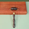 Wooden facial roller used in gentle skincare self-care ritual