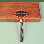 Wooden facial roller used in gentle skincare self-care ritual