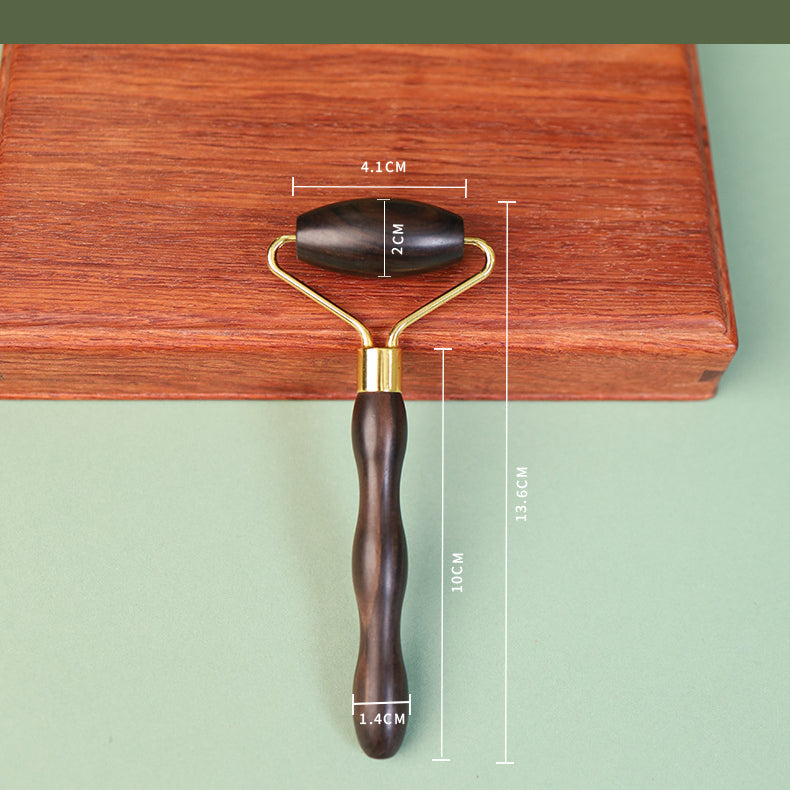 Wooden facial roller used in gentle skincare self-care ritual
