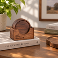 Black walnut coaster set with matching wooden holder, displayed in a warm home setting.