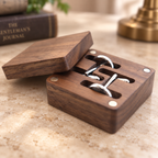 Black walnut cufflink box with a compact lidded design, styled in warm natural light.