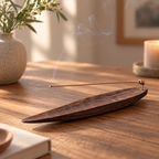 Black walnut incense holder with a brass insert for burning stick incense on a wooden tabletop.