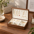 Black walnut jewelry box with a soft lined interior, designed for organizing necklaces, rings, bracelets, and watches.