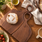 Pair of black walnut serving boards with natural wood grain and engraved messages, displayed together on a countertop.