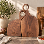 Set of two personalized black walnut steak boards with engraved “Little Sis” and “Big Sis” text, styled as a thoughtful sisters gift.