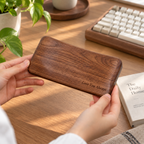 Wooden mouse wrist support made from black walnut for a neat and comfortable desk setup.