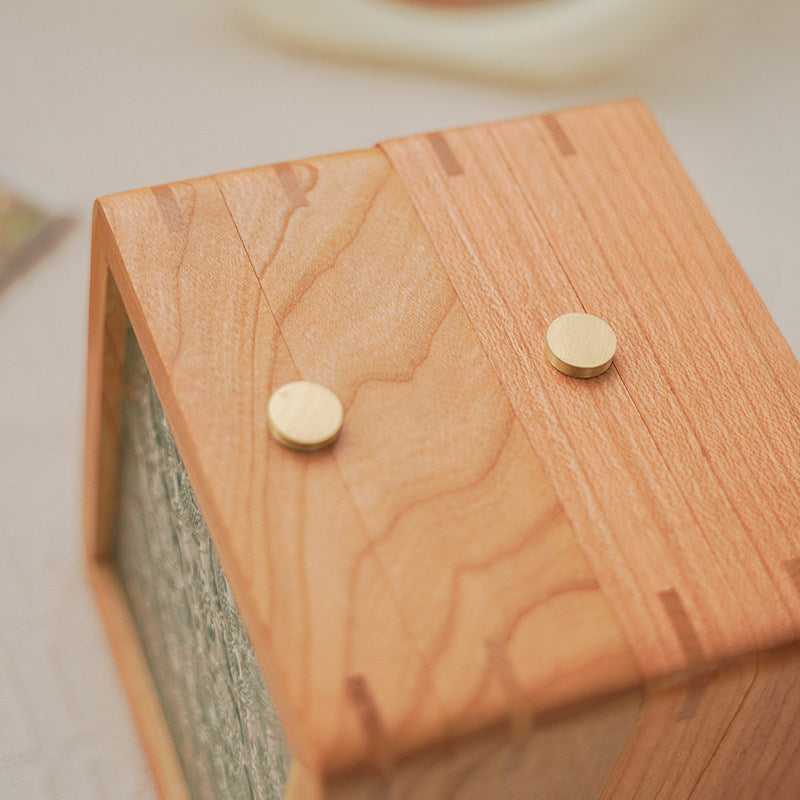 Cherry wood jewelry box for storing necklaces, bracelets, rings, and other small personal items.