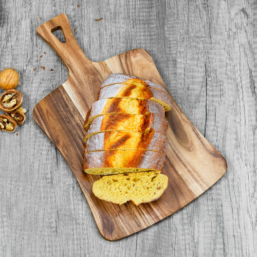 Xigura Patina handcrafted acacia serving board, main view in soft natural light for a warm, quiet home.