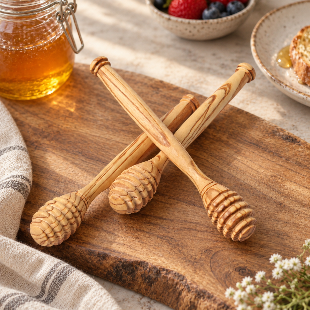 Olive wood honey dipper showing distinctive natural grain and a smooth handcrafted finish.