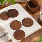 Personalized wooden coaster set with engraved holder, styled as a thoughtful housewarming or friendship gift.