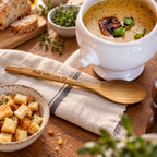 Olive wood cooking spoon with a smooth handcrafted surface for serving soup, stews, and everyday meals.