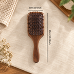 Black walnut wooden paddle brush styled for a simple everyday hair care routine.