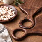 Wooden steak serving board with a rounded handle for serving steak, bread, cheese, and everyday meals.