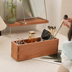 Close-up of a wooden storage box with divided compartments for sorting small daily items.