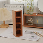 Wooden vanity organizer with compartments for perfume, brushes, scissors, and small accessories.